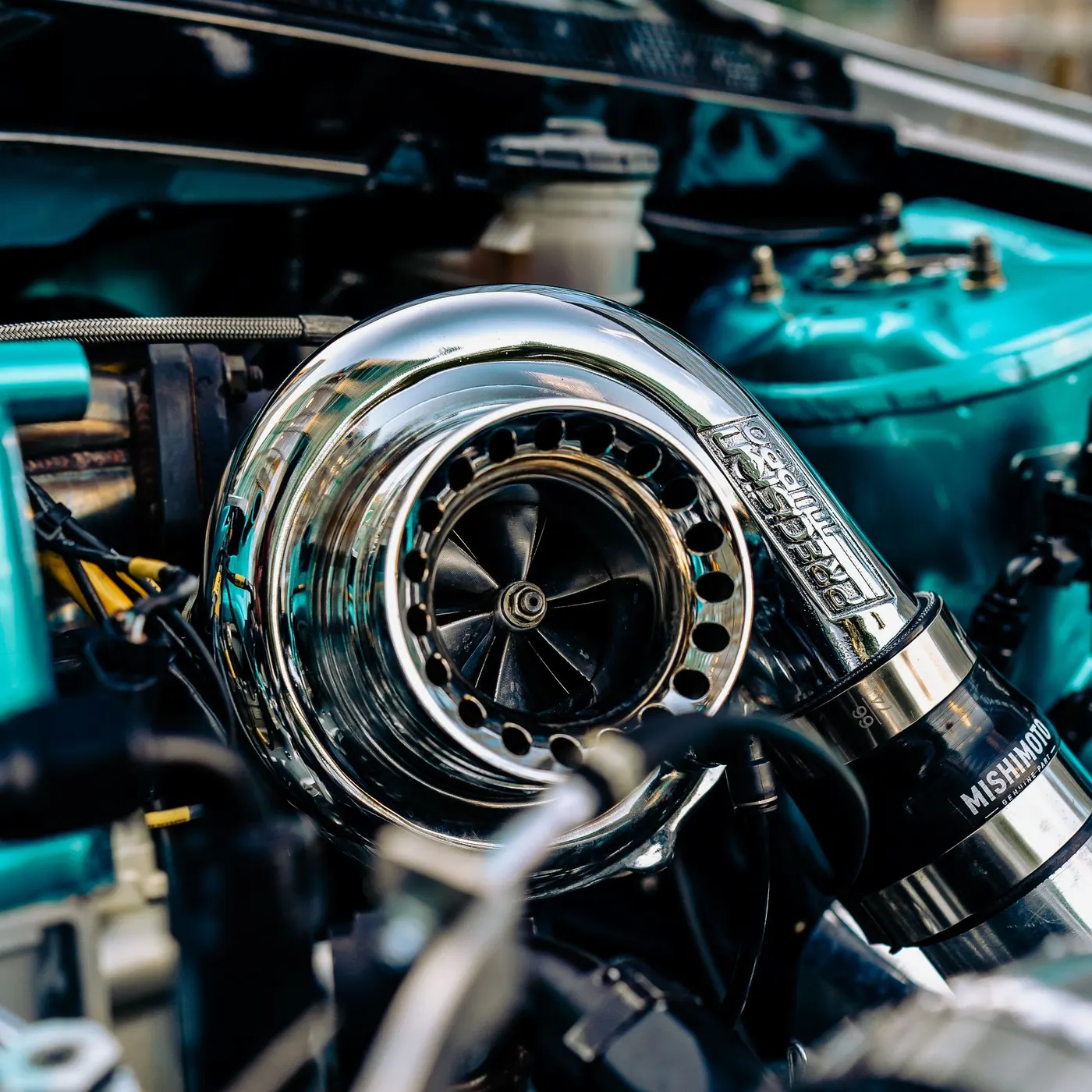 Polished billet compressor housing mounted in an engine bay